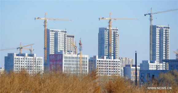 Photo taken on Nov. 18, 2015 shows residential buildings under construction in Changchun, northeast. China will cut deed and business taxes for home purchases in most cities in an attempt to digest the property glut, an official statement said on Friday, Feb 19, 2016. (Xinhua/Zhang Nan)