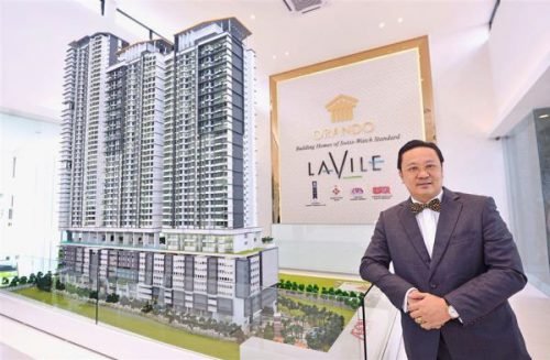 Orando managing director Datuk Eng Wei Chun posing with a scale model of the Lavile Kuala Lumpur. (Photo from The Star)