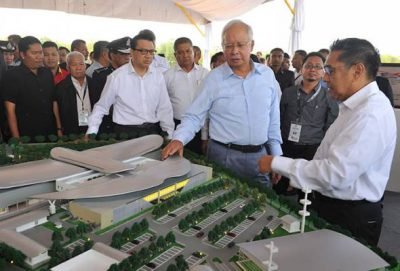 Prime Minister Datuk Seri Najib Tun Razak and DCA director-general Datuk Seri Azharuddin Abdul Rahman looking at a model of the KL ATCC, here today. - BERNAMA pic